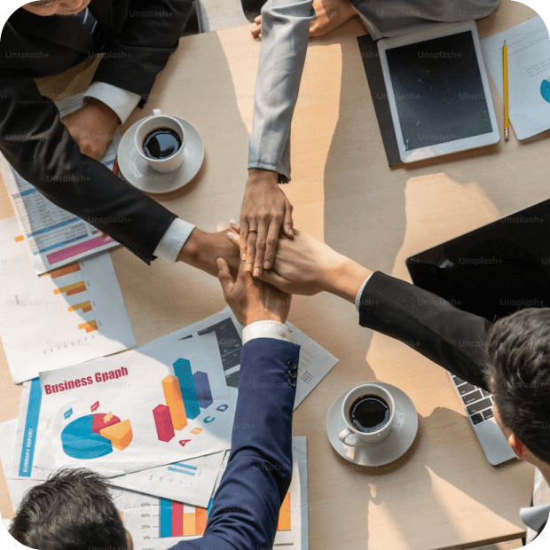 Team putting hands together — our culture